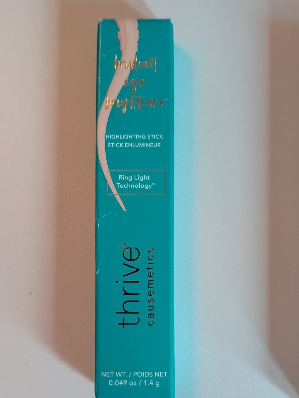 thrive causemetics Highlighting Stick in Turquoise Box with Light Pink Accent
